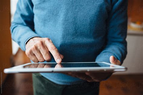 Detail Of The Hands Of A Senior Man Using A Digital Tablet By Stocksy