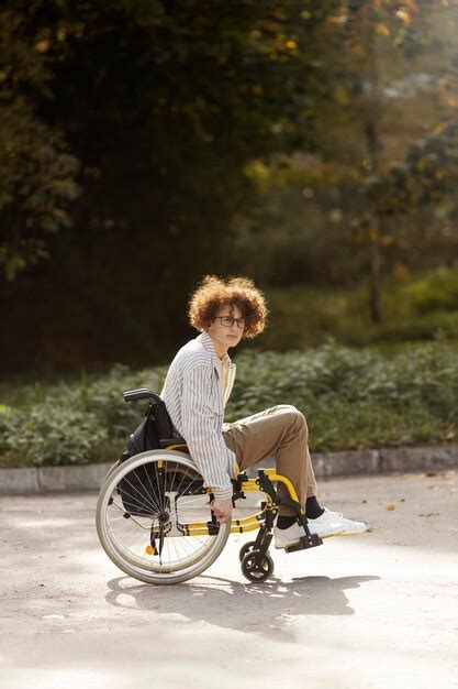 Premium Photo Young Redhaired Guy In Glasses Sits In A Wheelchair Sad