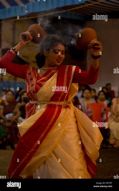 Traditional Bengali woman performing the Dhunuchi Dance during the ...