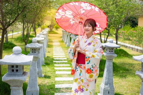 Young Woman Wearing A Japanese Traditional Kimono Or Yukata Holding An