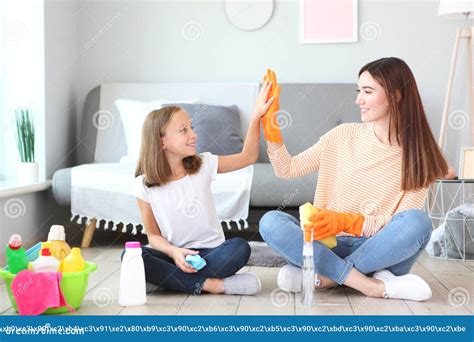 Mother And Daughter In A Good Mood Are Cleaning The House Stock Image