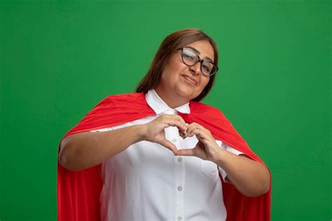 Free Photo Pleased Middle Aged Superhero Female Wearing Glasses Showing Heart Gesture Isolated