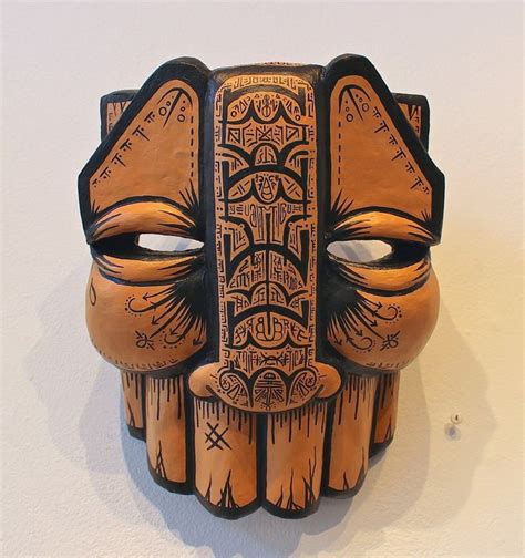 a wooden mask is hanging on the wall