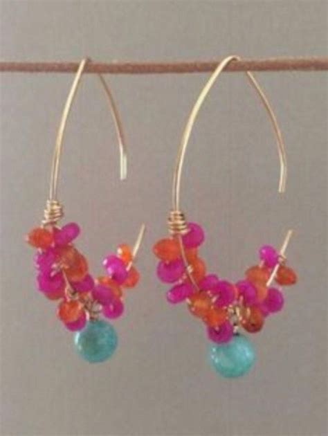 Two Pairs Of Earrings With Colorful Beads Hanging From Them