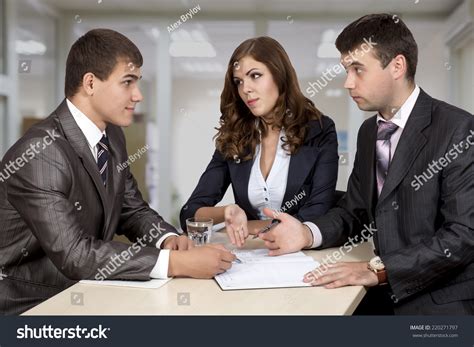 Negotiating Deal Three Business People Discuss Stock Photo 220271797