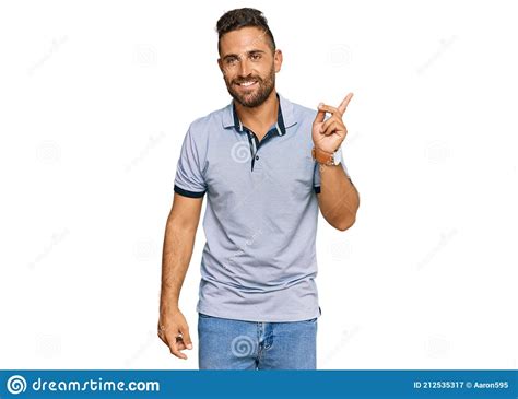 Handsome Man With Beard Wearing Casual Clothes With A Big Smile On Face Pointing With Hand