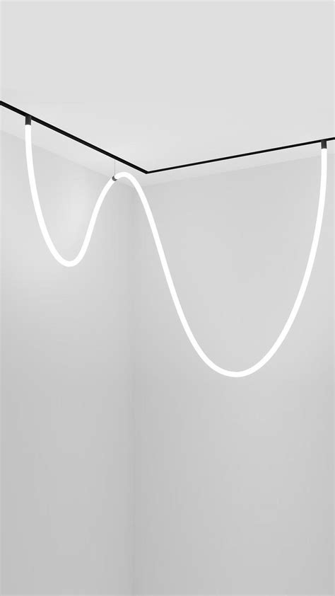 a white room with some lights hanging from it's ceiling and an object ...