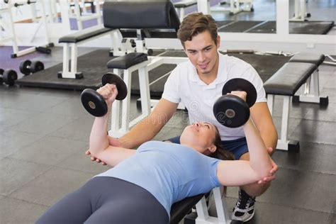 Personal Trainer Helping Client Lift Dumbbells Stock Image Image Of