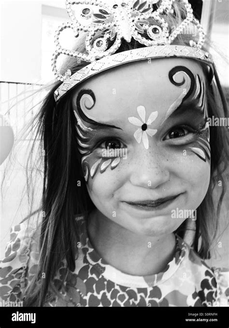 Girl with face paint and tiara Stock Photo - Alamy