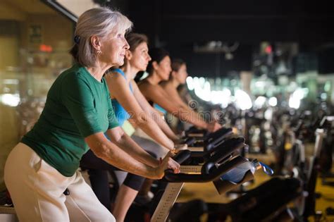 Mature Woman Taking Cycling Class At Gym Stock Photo Image Of