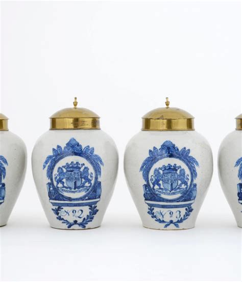 D1368 Set Of Four Blue And White Armorial Tobacco Jars And Brass