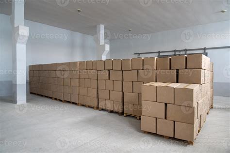 A Pile Of Craft Boxes Stacked On Top Of Each Other In A White Warehouse