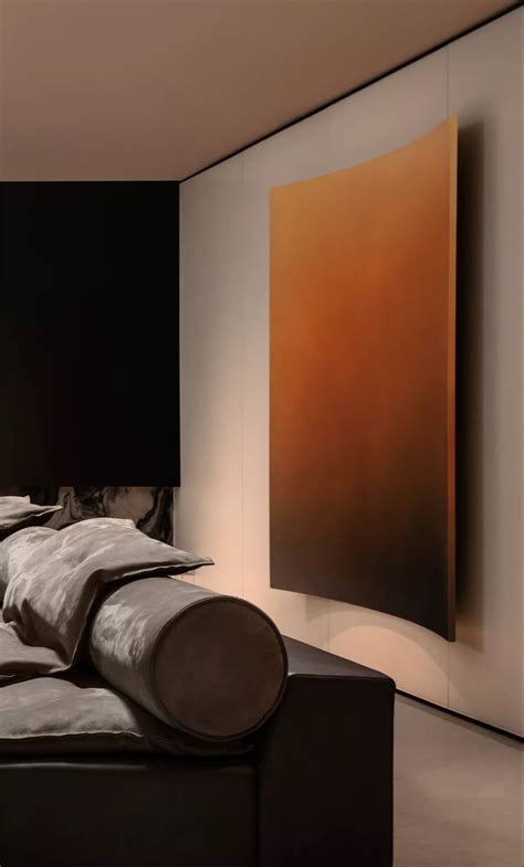 A Large Painting Hanging On The Wall Above A Bed In A Room With Black Walls