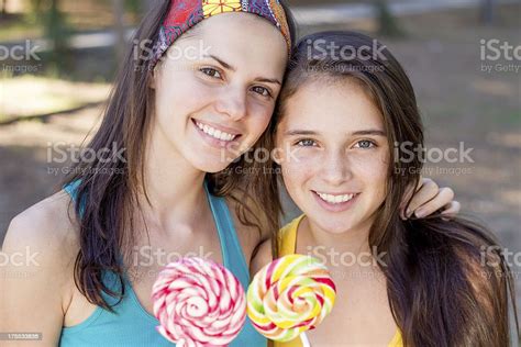 Two Teenage Sisters Girl With Lollipop Candy Outdoors Summer Smiling