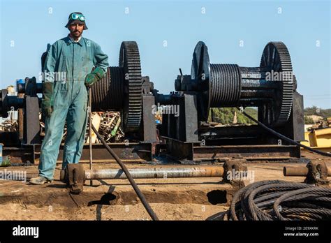 Worker breaking up ship at Gadani ship-breaking yard, located across a ...