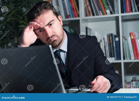 Sad And Thoughtful Businessman Watching Laptop Display Stock Image