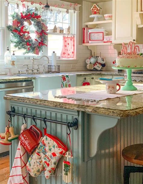 A Kitchen Decorated For Christmas With Stockings Hanging On The Rack