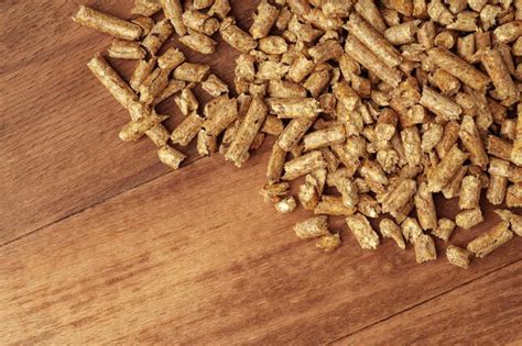 Premium Photo Heap Of Wooden Pellets Biofuel On Wooden Table