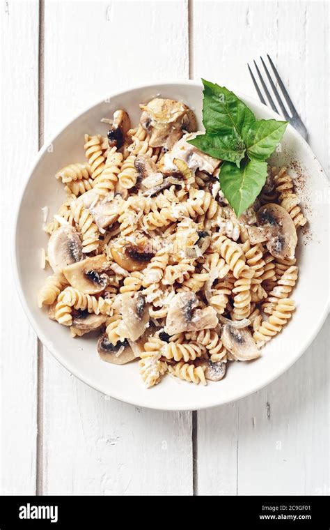 Fusilli Pasta With Mushrooms And Cheese Stock Photo Alamy