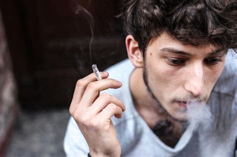 Premium Photo Close Up Of Man Smoking Cigarette