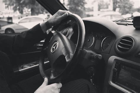 Grayscale Photography of Person Driving a Car · Free Stock Photo