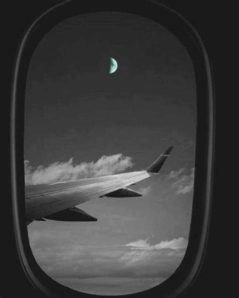 An Airplane Wing With The Moon In The Sky As Seen Through It S Window