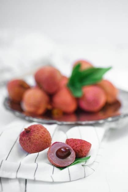 Premium Photo Fresh Ripe Lychee Fruit And Peeled Lychee With Green