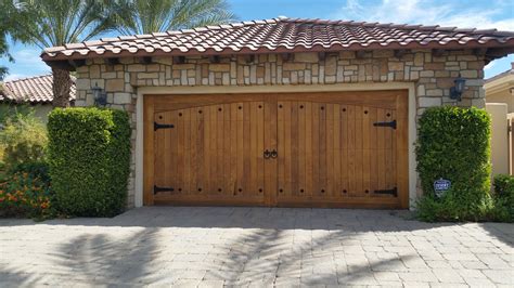 arched trim design wood garage door with knotty Cedar | Garage Doors and Gates