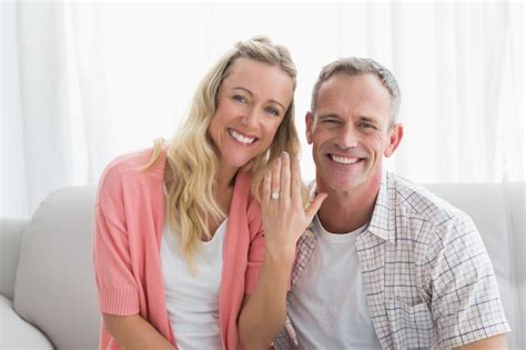 Premium Photo Happy Woman Showing Engagement Ring Besides Man