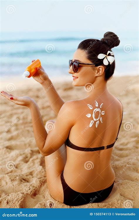 Woman Apply Sun Cream Protection Cream On Her Tanned Shoulder