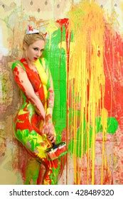 Beautiful Naked Blonde Woman Painting Wall Stock Photo