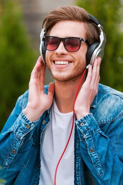 Premium Photo Enjoying His Favorite Music Cheerful Young Man In