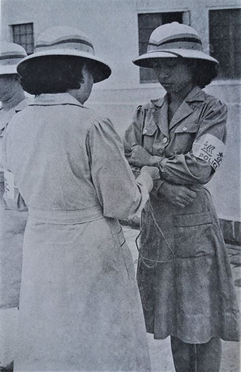 A Filipino women with the collaborationist police. Caption: "…The women ...