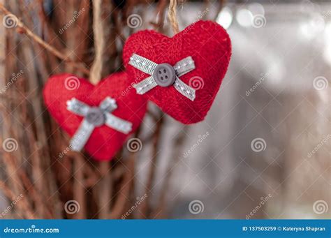 Two Knitted Hearts Hanging On A Branch Symbol Of Love And Valentine`s