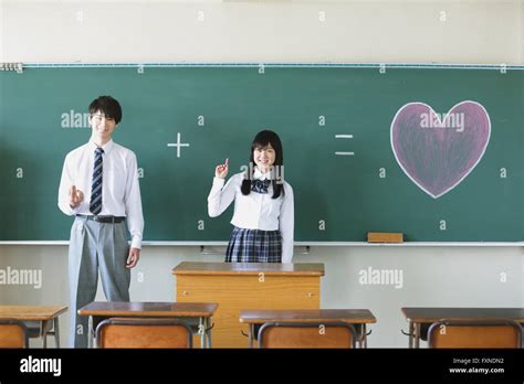 Japanese High School Students In Front Of Classroom Blackboard Stock