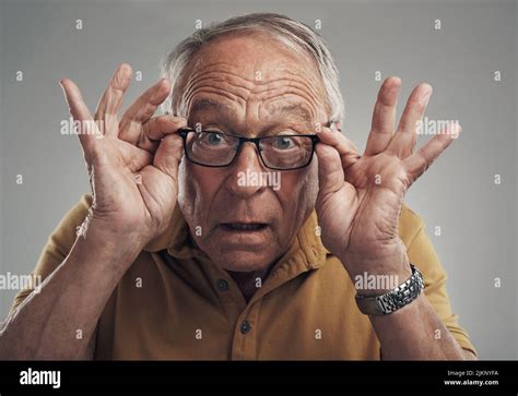 I Can See Clearly Now Studio Shot Of An Elderly Man Adjusting His