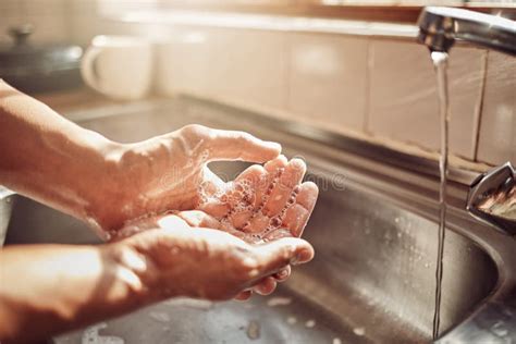 Wash It Good Before You Touch The Food An Unrecognisable Man Washing His Hands In The Kitchen