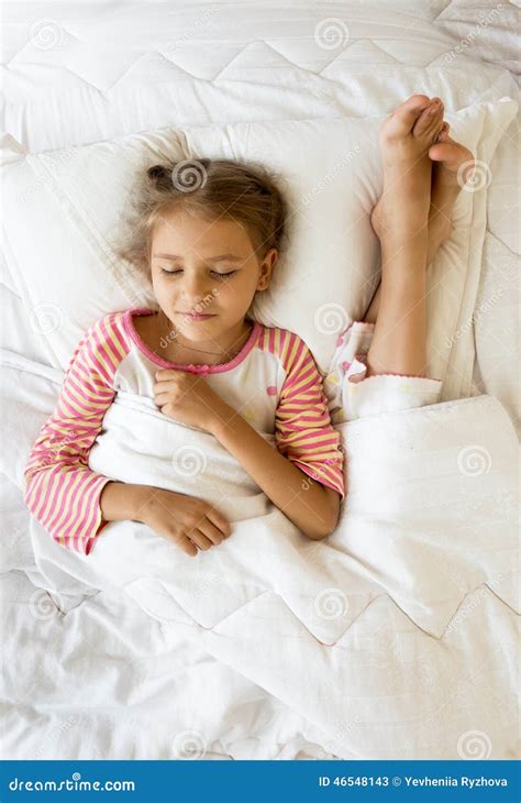 Girl Lying Next To Sisters Feet On Pillow Stock Image Image Of