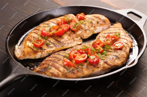 Premium Ai Image A Closeup Of Sizzling Catfish Steaks On A Cast Iron Pan