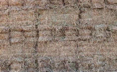 A Close Up View Of The Background Of Many Bales Of Compressed Rice