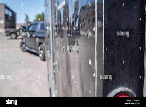 Trailer Being Pulled By A Truck In Industrial Parking Lot Stock Photo