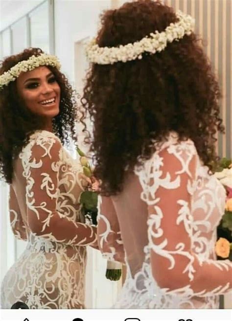 Two Women In Wedding Dresses Looking At Each Other