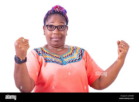 Serious Mature Woman Wearing Glasses Standing While Raising Her Fists