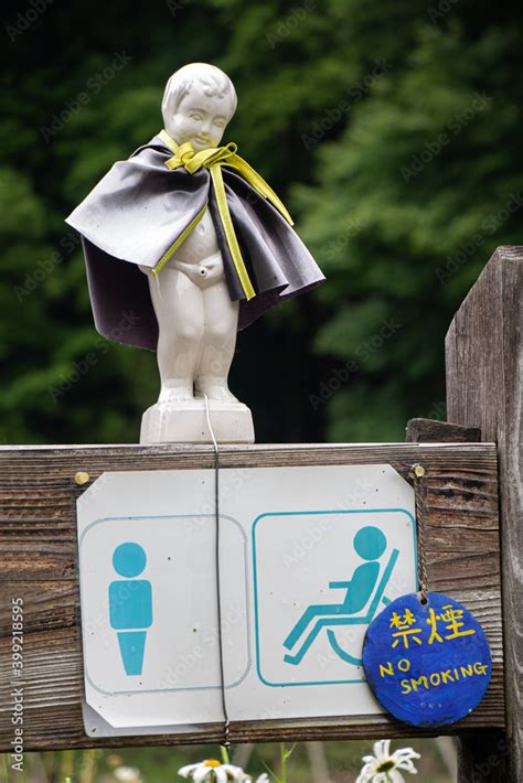 The Toilet Sign With A Figurine Of A Pissing Boy On A Wooden Railing Japanese Countryside