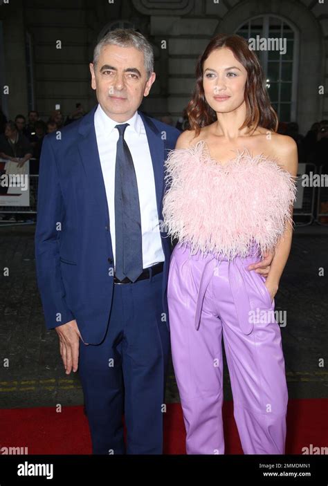 Actors Rowan Atkinson And Olga Kurylenko Pose For Photographers Upon