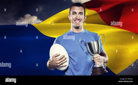 Composite Image Of Portrait Of Smiling Rugby Player Holding Trophy And