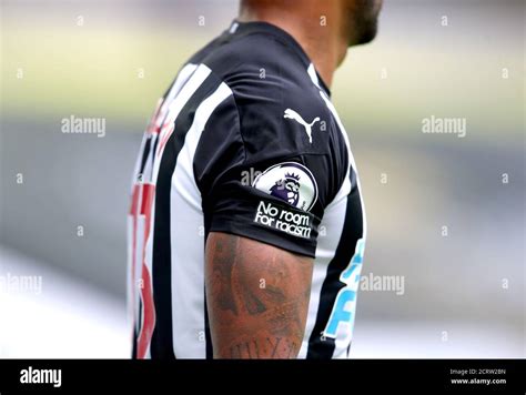 A Detailed View Of The No Room For Racism Badge On The Shirt Of