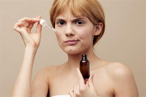 Premium Photo Portrait Of Young Woman Applying Nail Polish Against