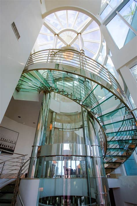 Florida Beach Pad With Round Glass Elevator For 6m Glass Elevator Glass Staircase Round Stairs