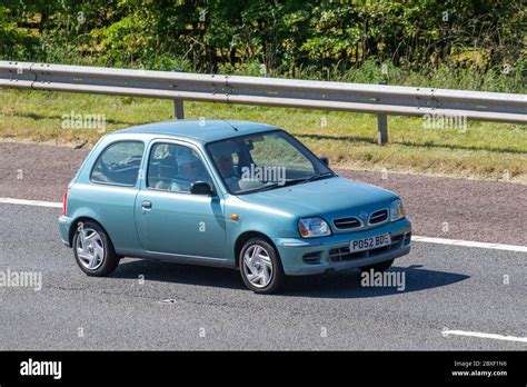 2002 Blue Nissan Micra S Vehicular Traffic Moving Vehicles Cars